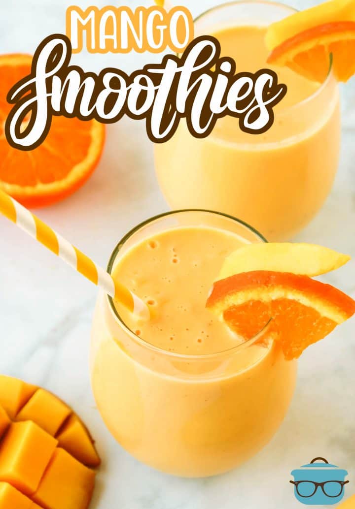 Overhead of two Mango Smoothies garnish with fruit slices and straws in each glass.