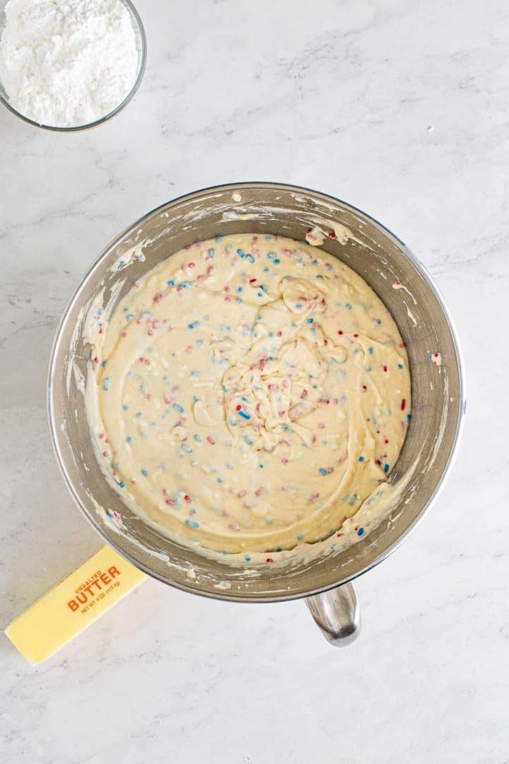 Sprinkles folded in to batter in bowl of stand mixer