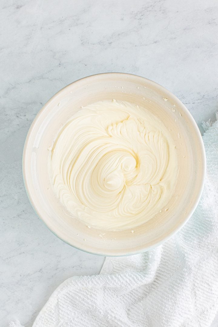 Frosting mixed up in white bowl