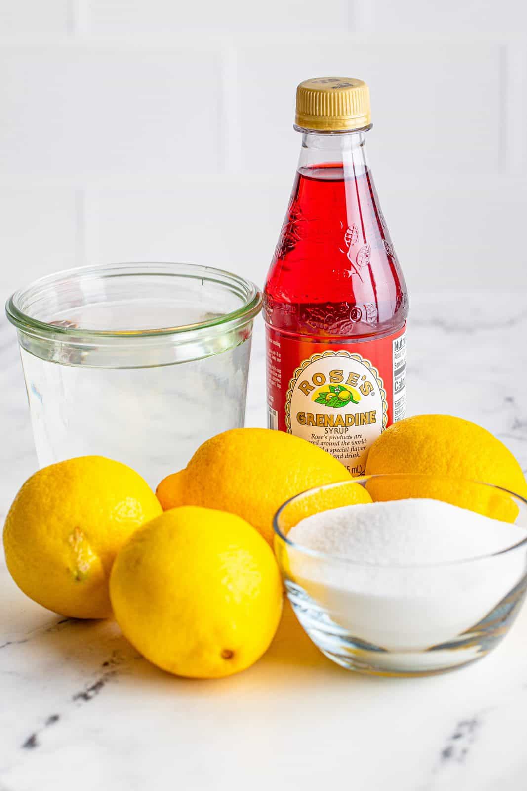 Ingredients needed to make Homemade Pink Lemonade: water, sugar, lemon juice and grenadine.
