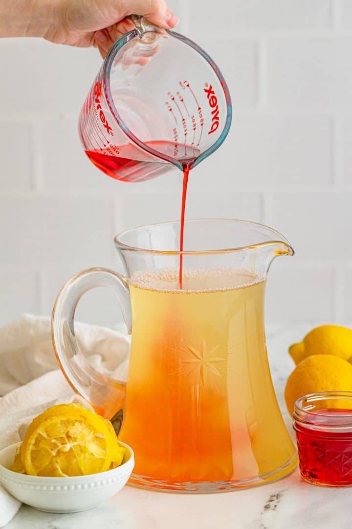 Grenadine being poured into pitcher