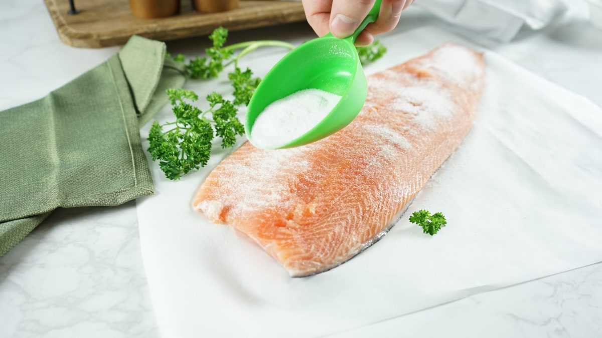 Salmon being sprinkled with salt