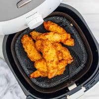 Square image overhead of finished Chicken Crispers in air fryer basket