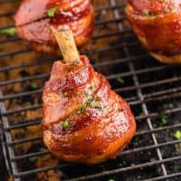 Square image close up of one Smoked Bacon Wrapped Chicken Lollipop