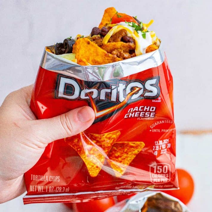 Hand holding up bag of Doritos Walking Tacos square image