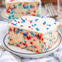 Square image of one slice of Funfetti Cake on white plate
