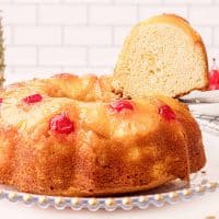Close up of finished Pineapple Upside Down Bundt Cake Recipe with slice being removed
