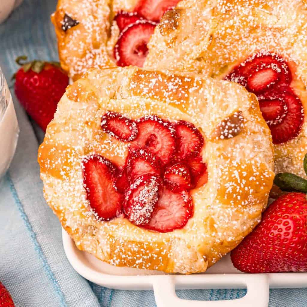 Square image of one Strawberry Cheese Danish topped with powdered sugar