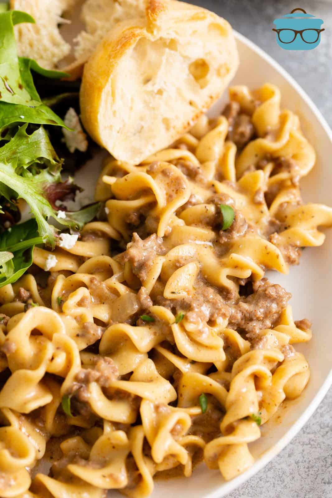 hamburger helper stroganoff serving on a white plate with a slice of French Bread.