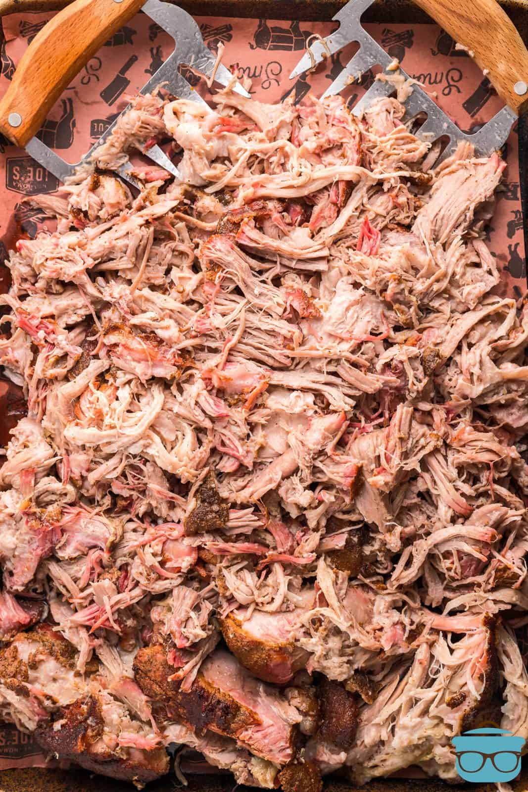 Overhead of shredded Smoked Pulled Pork on tray.