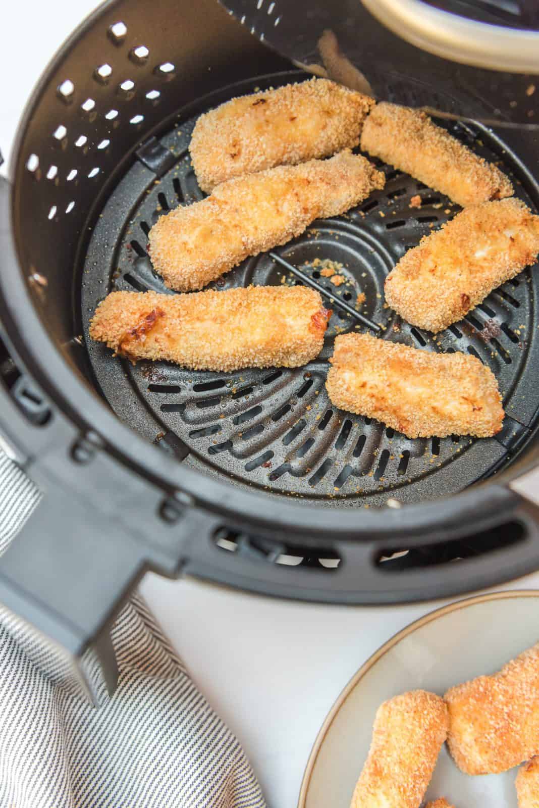 Finished fish sticks in air fryer.