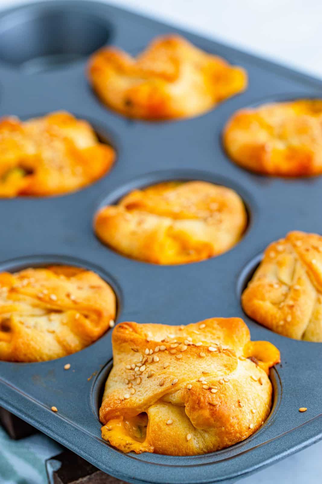 Easy Cheeseburger Crescent Cups right out of oven in muffin tin.
