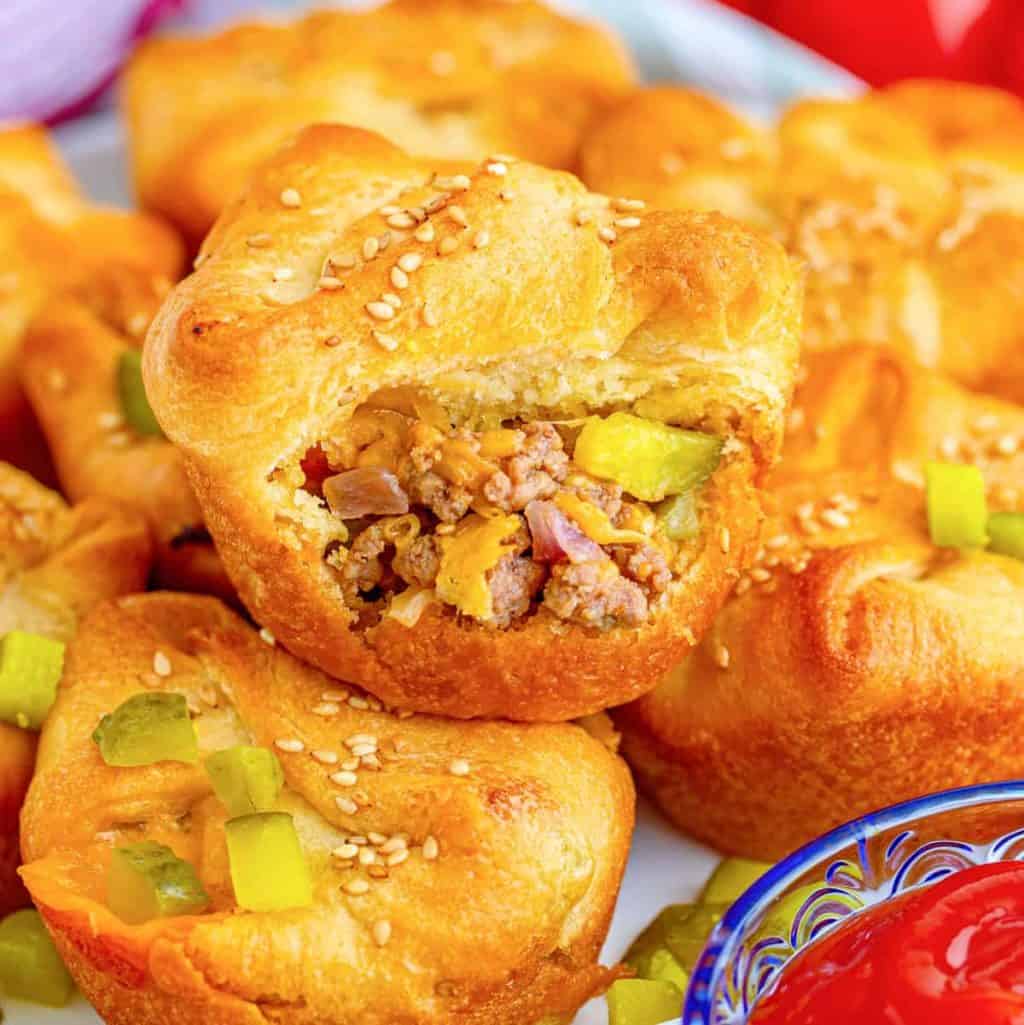 Close up of stacked Easy Cheeseburger Crescent Cups with top cup having bite out of it