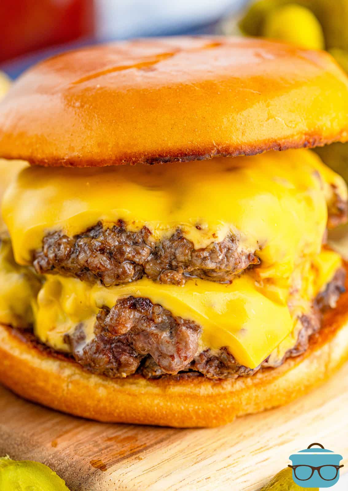 closeup photo of a double stacked hamburger on a bun with cheese