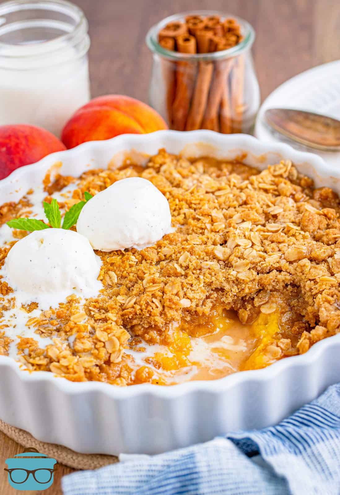 Fresh Easy Peach Crisp in baking dish with some of the crisp removed.