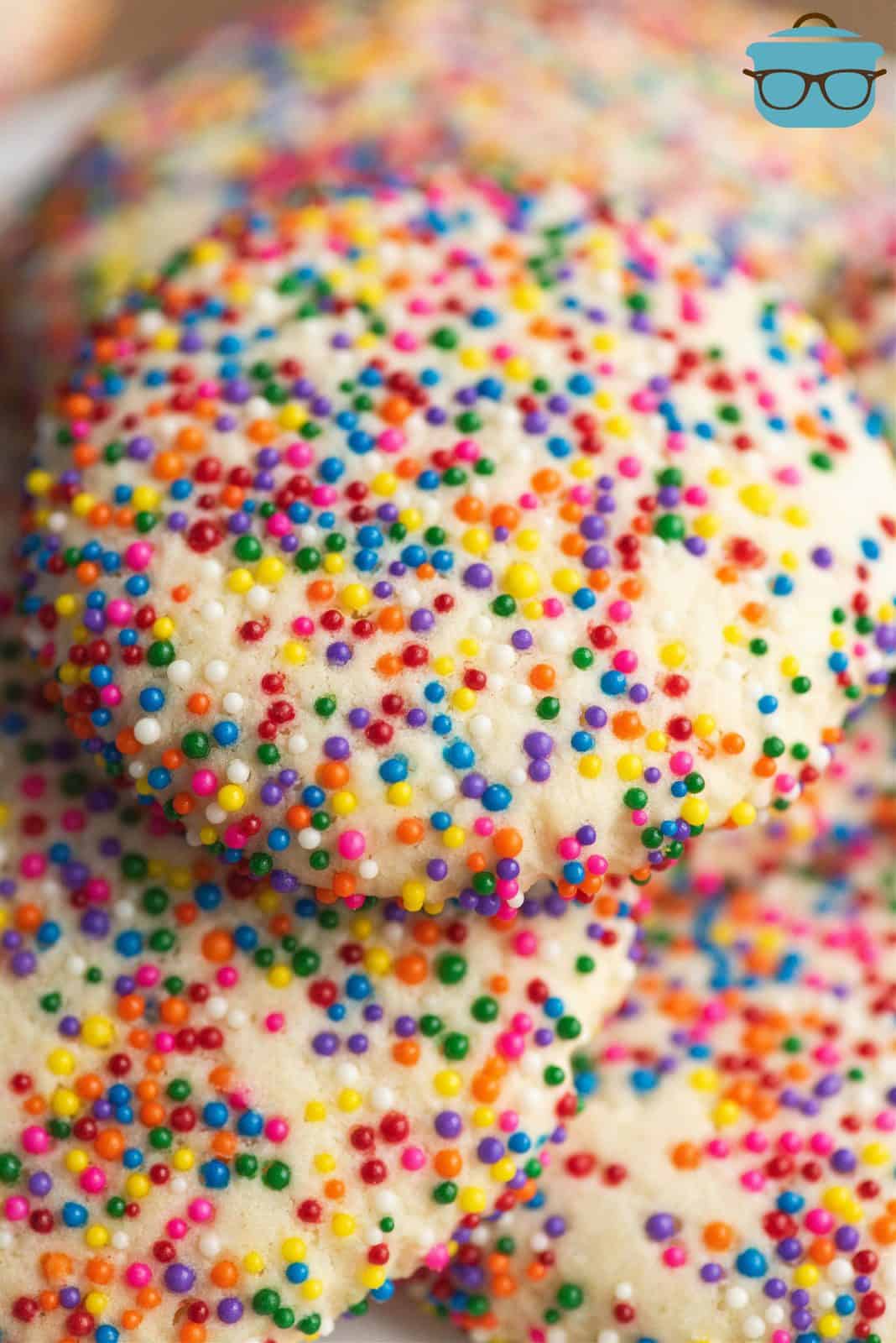 Close up of Sprinkle Cookies stacked on one another.