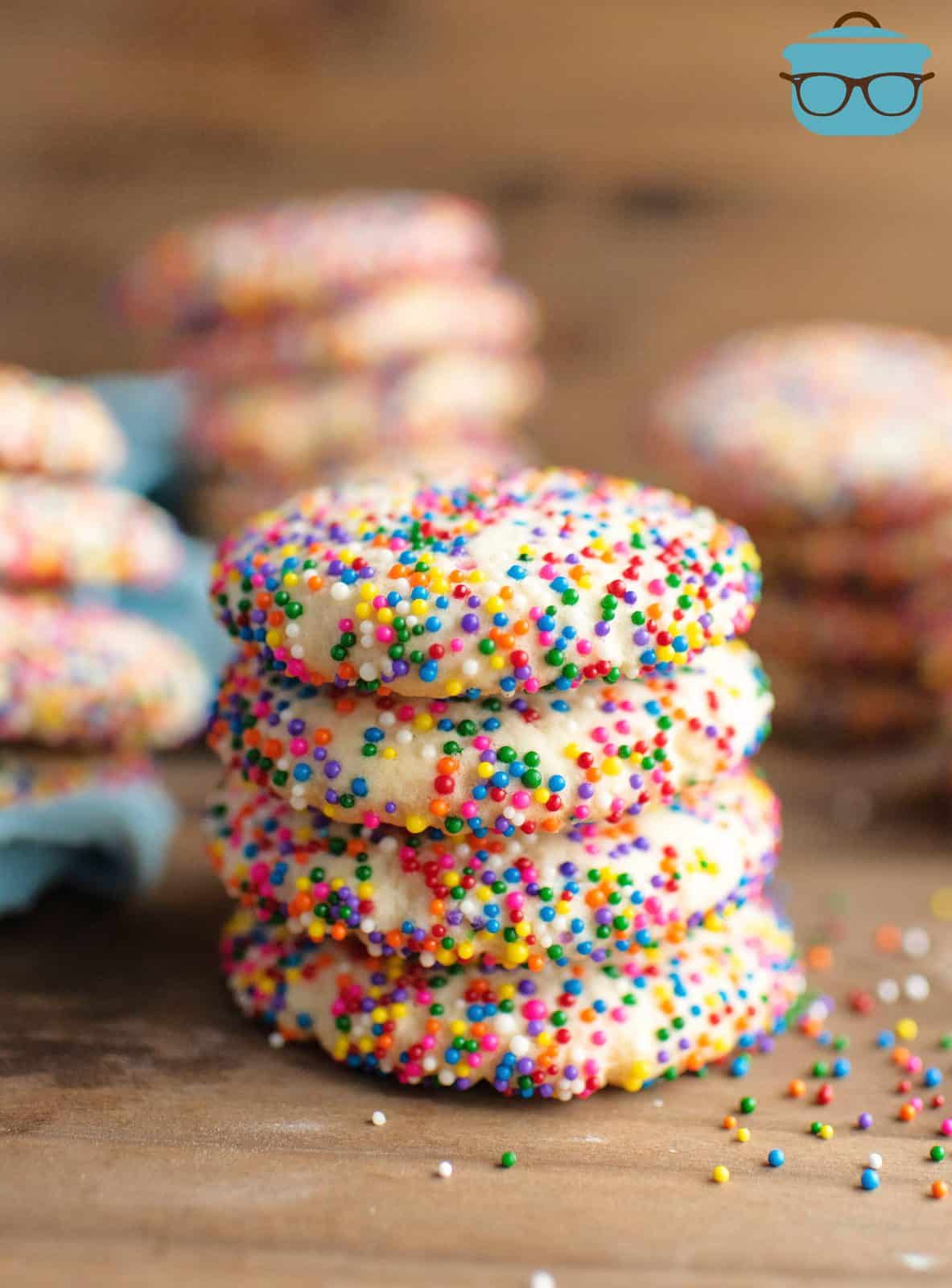 4 stacked Sprinkle Cookies with more cookies behind it.