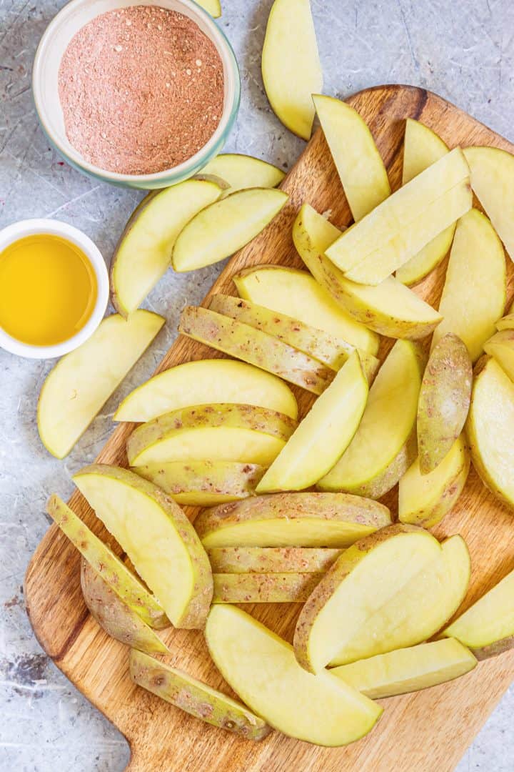 Cut up potatoes into wedges.