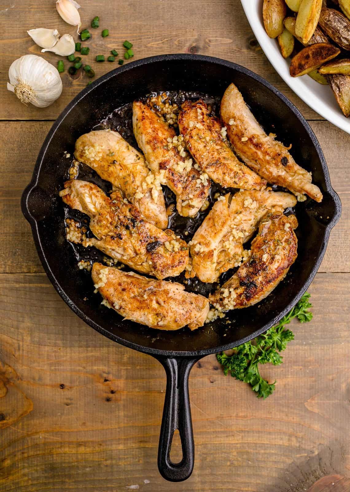 Browned chicken in skillet.