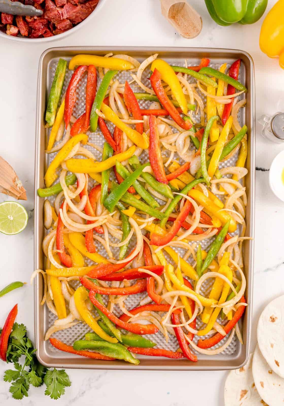 Vegetables spread out over sheet pan.