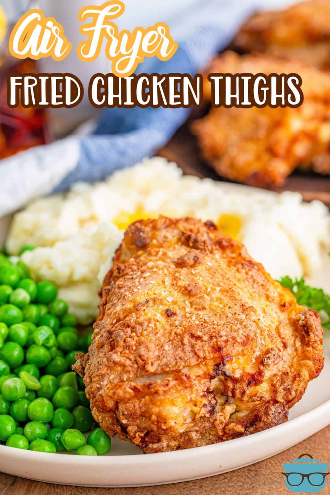 Pinterest image of Air Fryer Chicken Thighs on plate with peas and potatoes.