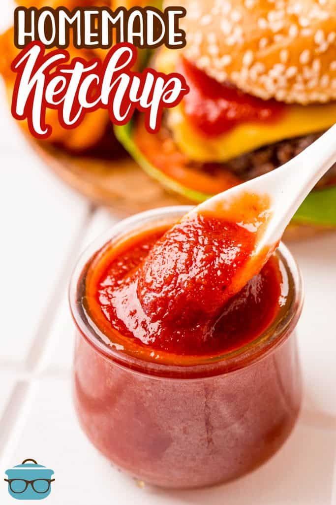 Pinterest image of spoon scooping Homemade Ketchup from clear jar.