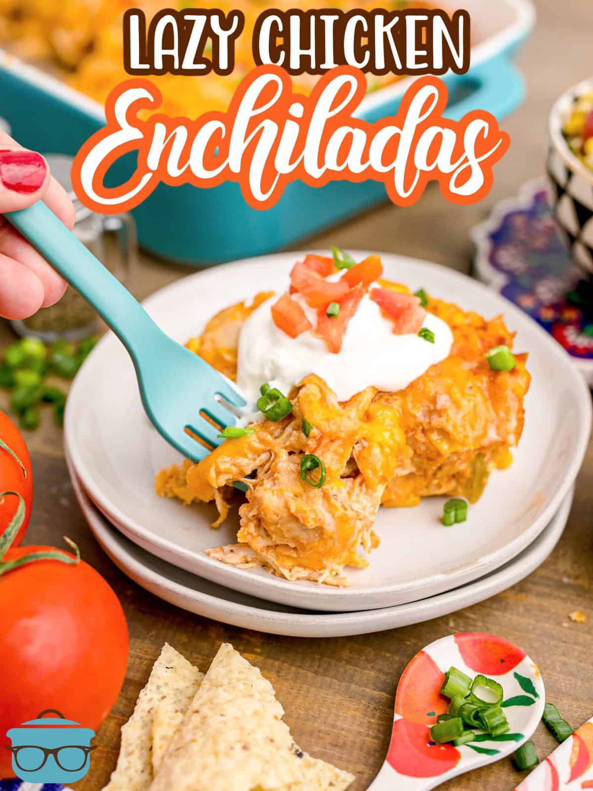 Lazy Chicken Enchiladas on plate with toppings and fork going into food.