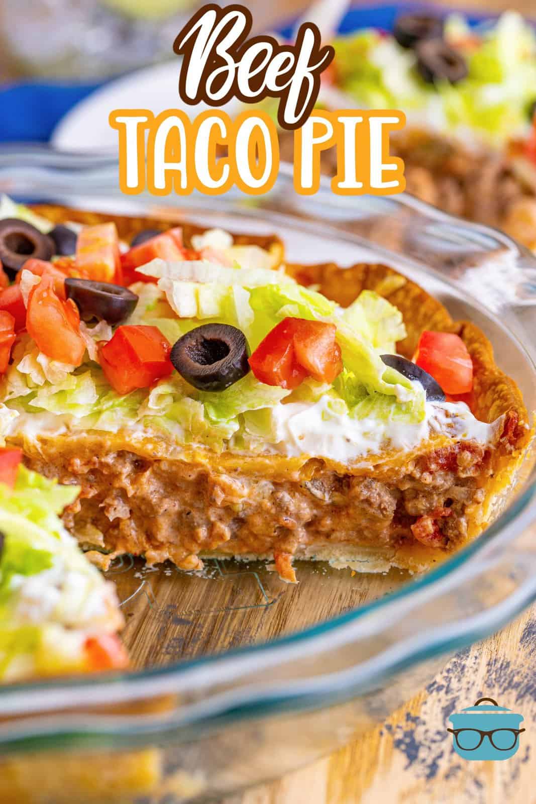 Taco pie shown in a pie pan with a slice removed. 