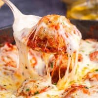 Square image of meatball being pulled up from Meatball Parmesan Skillet.