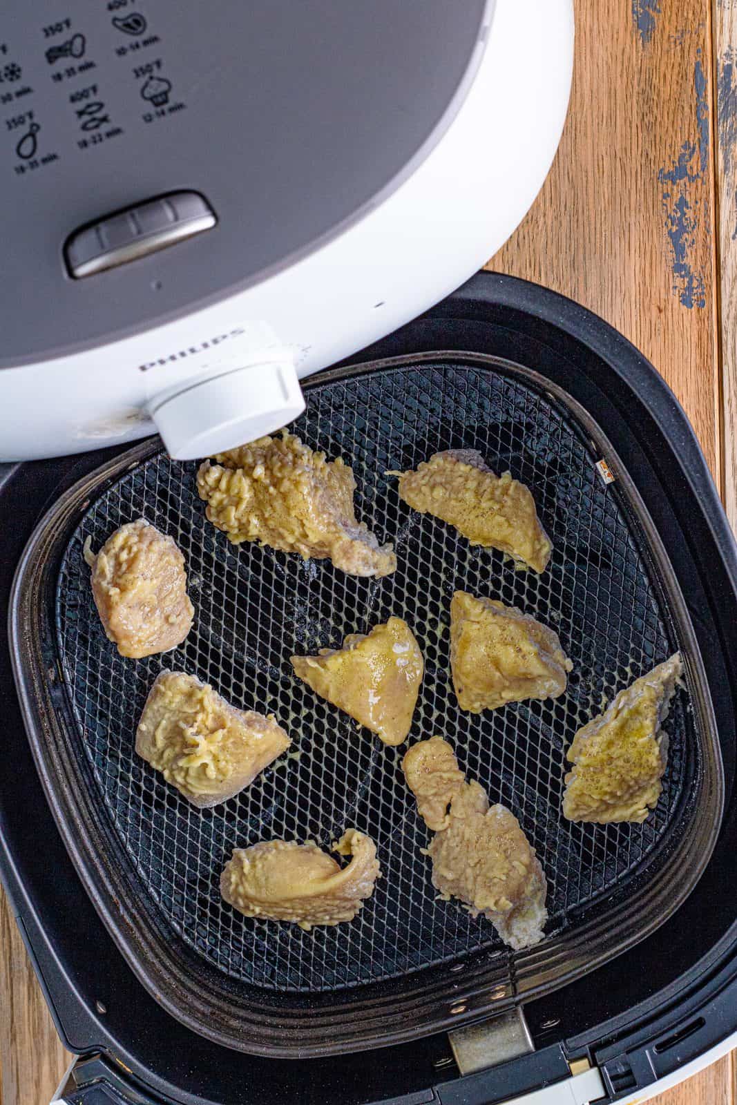 Chicken Nuggets added to air fryer and sprayed with cooking spray.