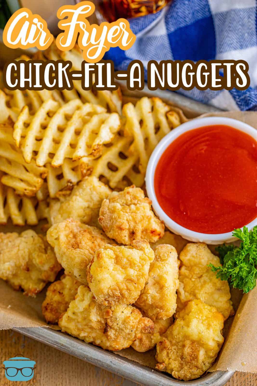 Pinterest image of Air Fryer Chick-Fil-A Chicken Nuggets on metal tray with Polynesian sauce and waffle fries.