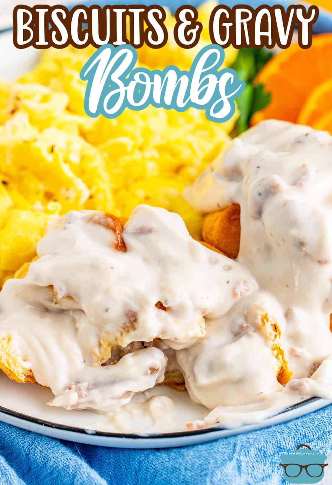 Biscuits and Gravy bombs cut open and shown on a plate with scrambled eggs. 