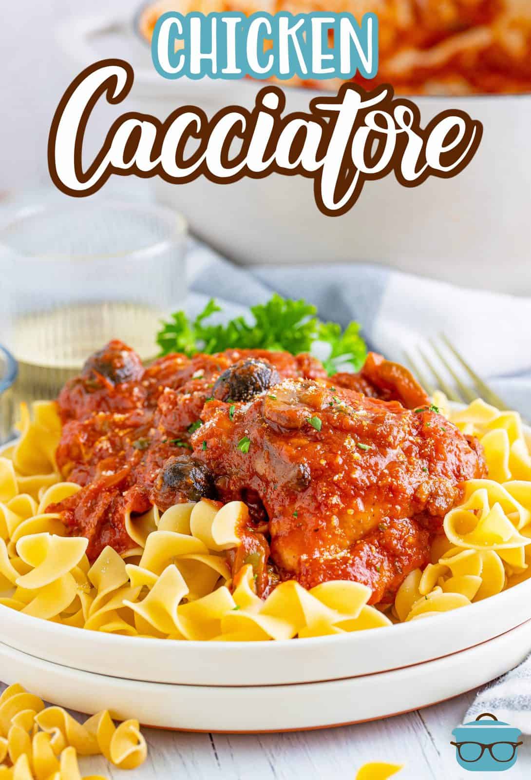 Chicken Cacciatore over noodles on white plate Pinterest image.