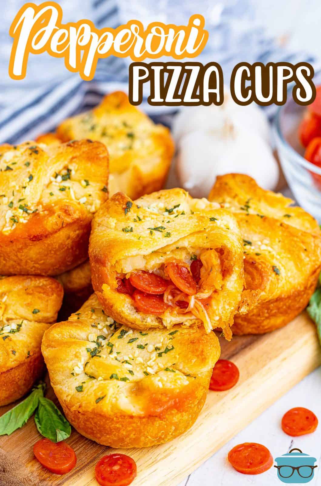 Overhead Pinterest photo of Pepperoni Pizza Cups stacked with bite taken out of one.