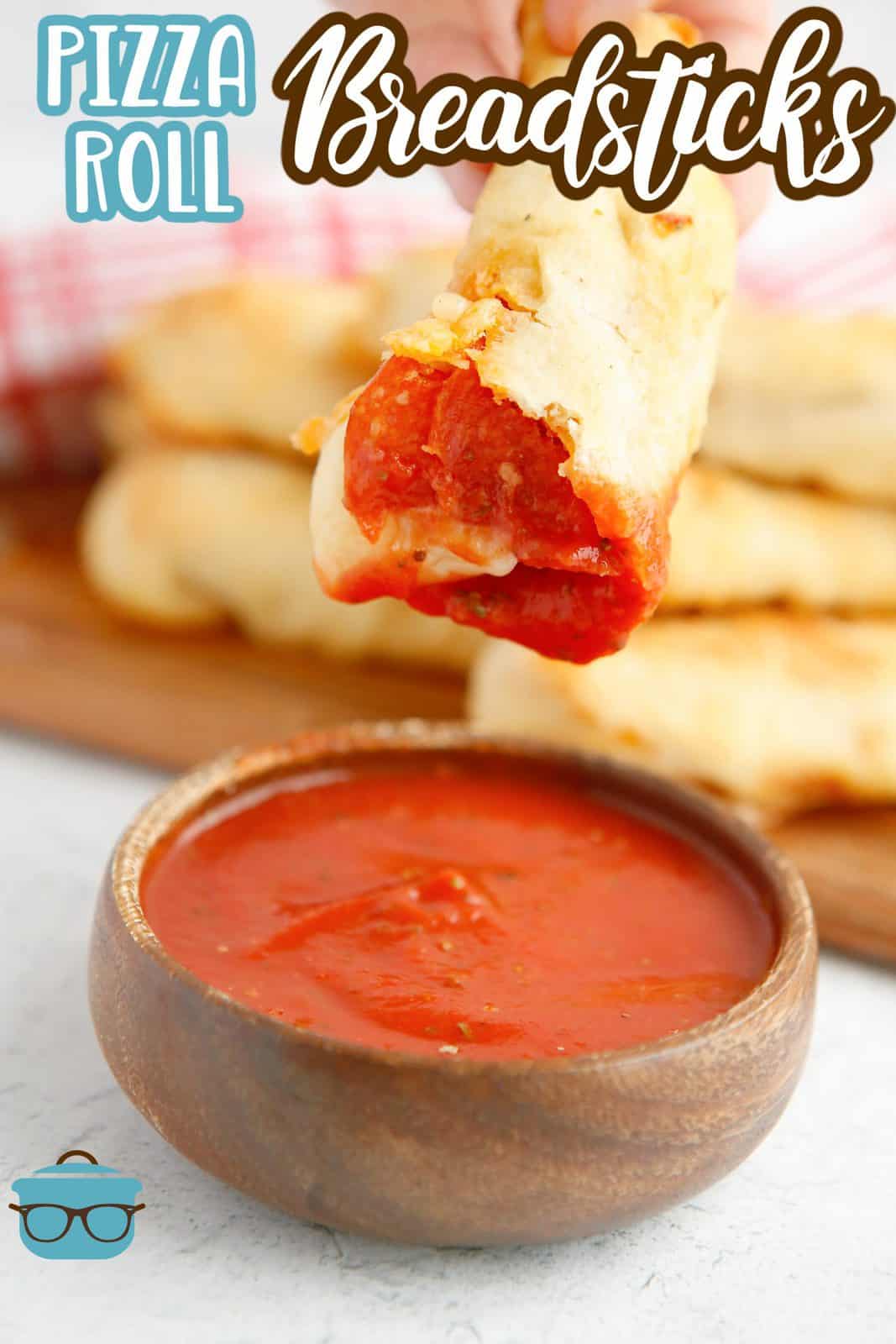 Pinterest image of one Pepperoni Roll Breadstick dipped in marinara sauce.