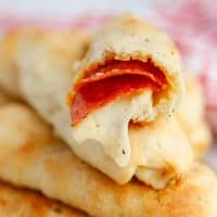 Square image of stacked Pizza Roll Breadsicks showing inside of one roll.