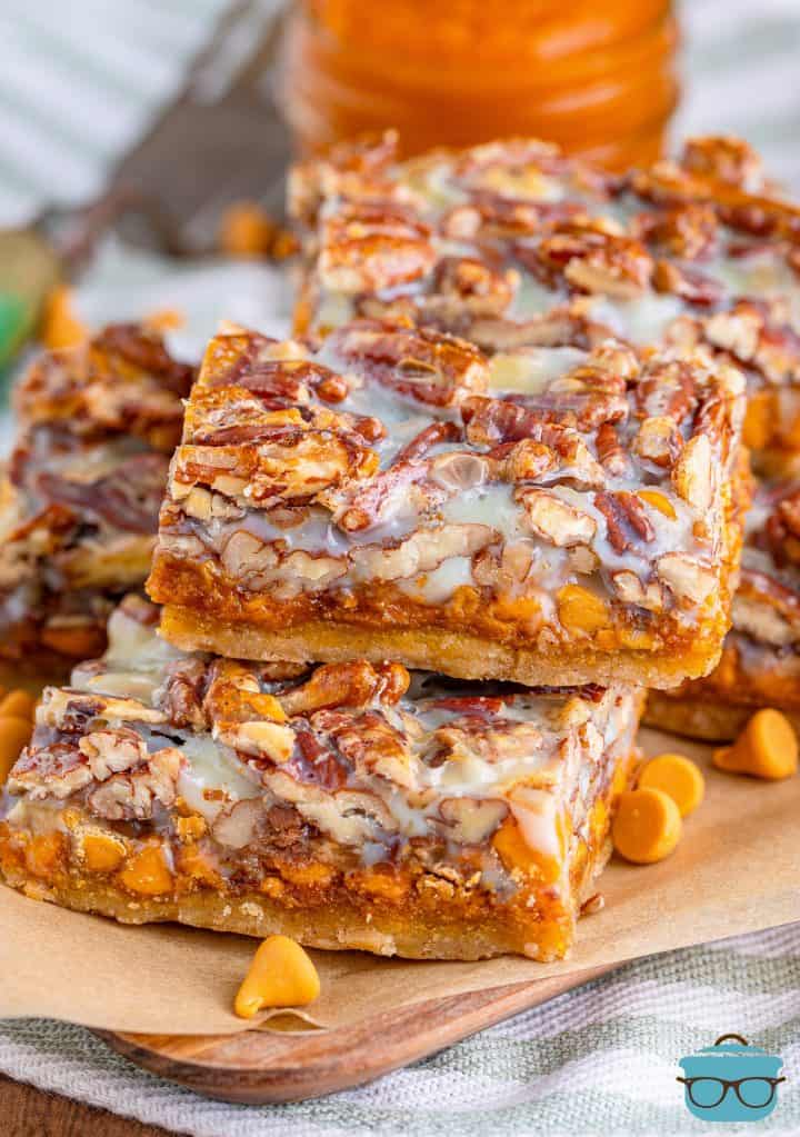 Stacked Pumpkin Magic Bars on marchment paper.