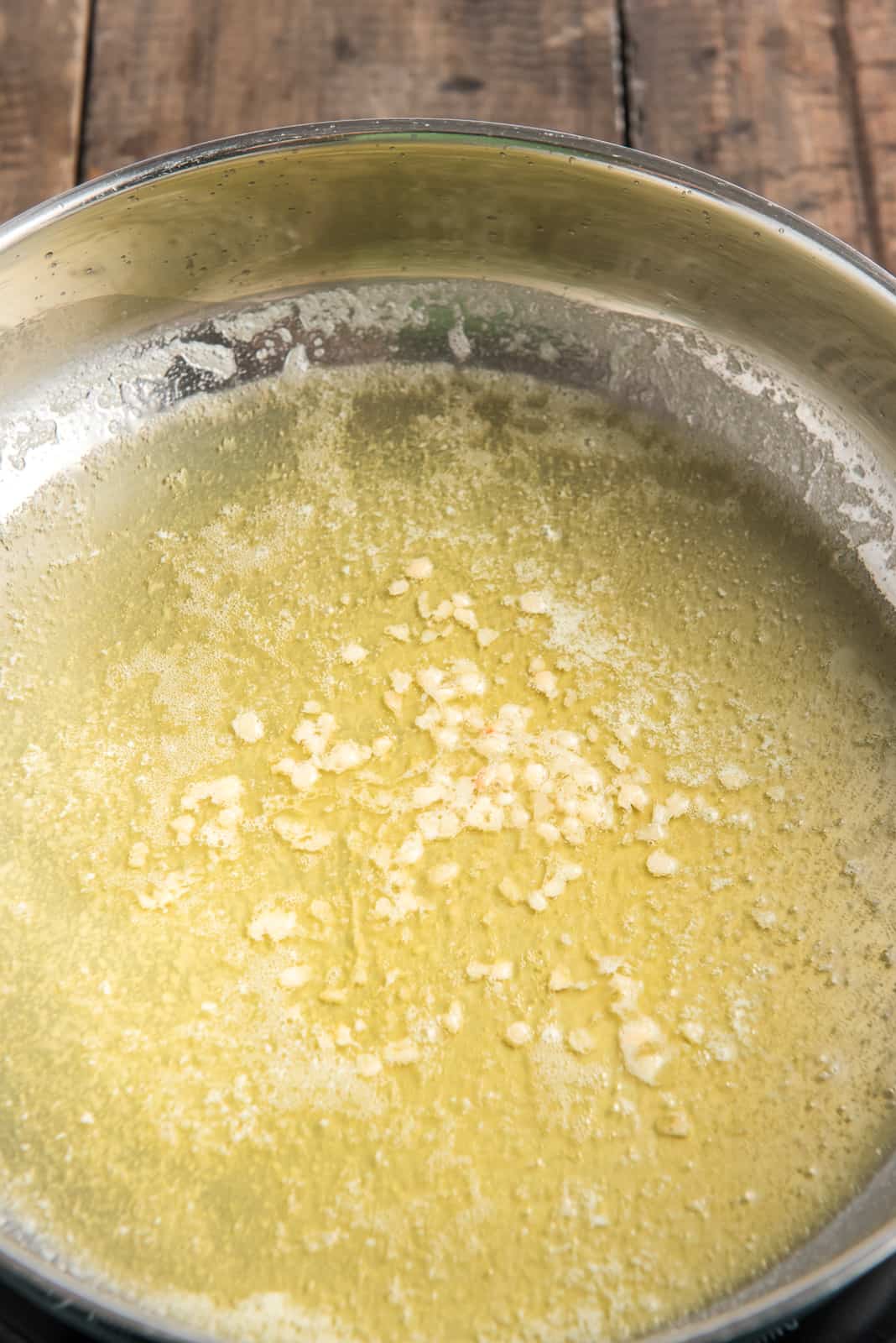 Olive oil, butter and garlic melted in pan.
