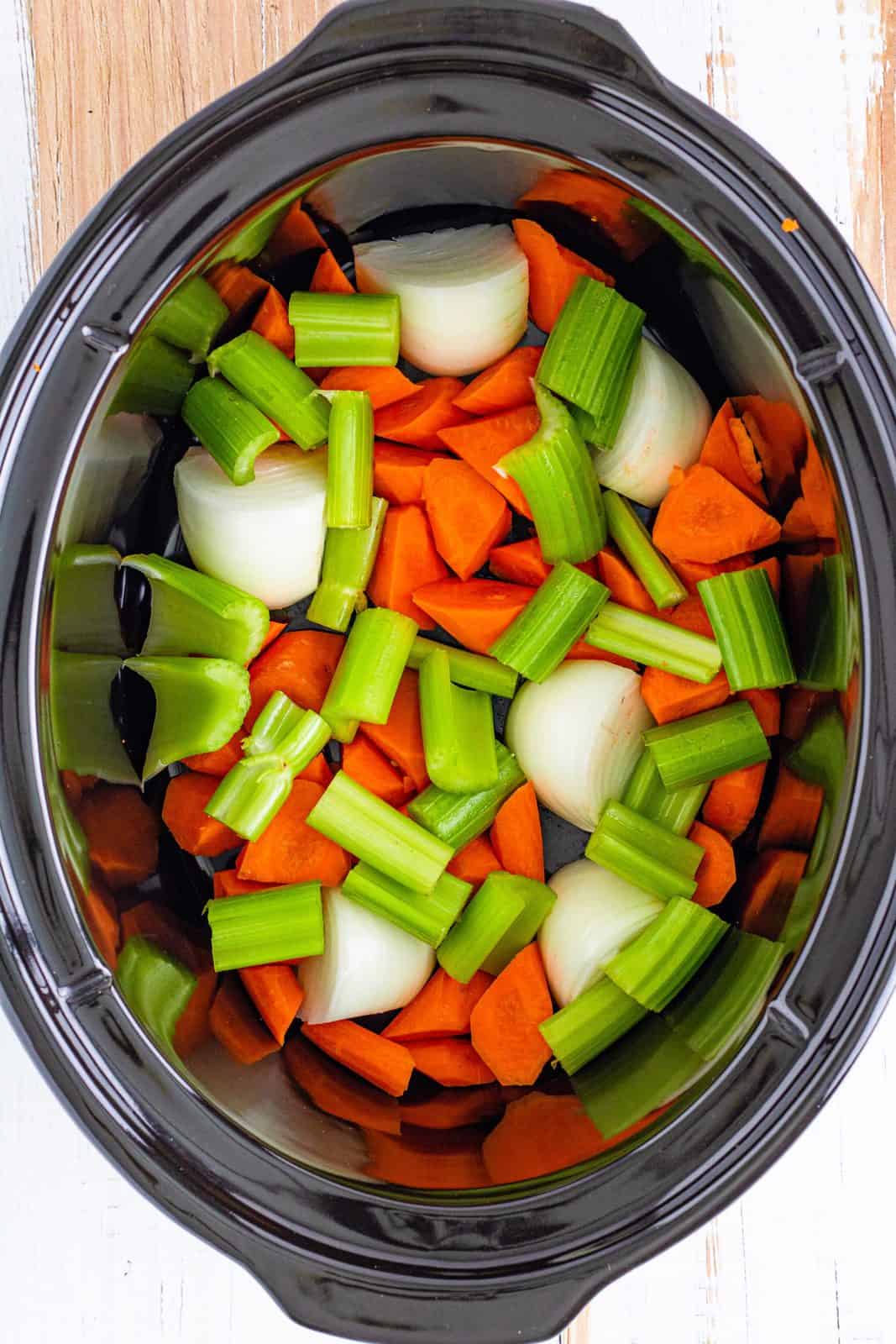 Chopped vegetables added to bottom of crock pot.