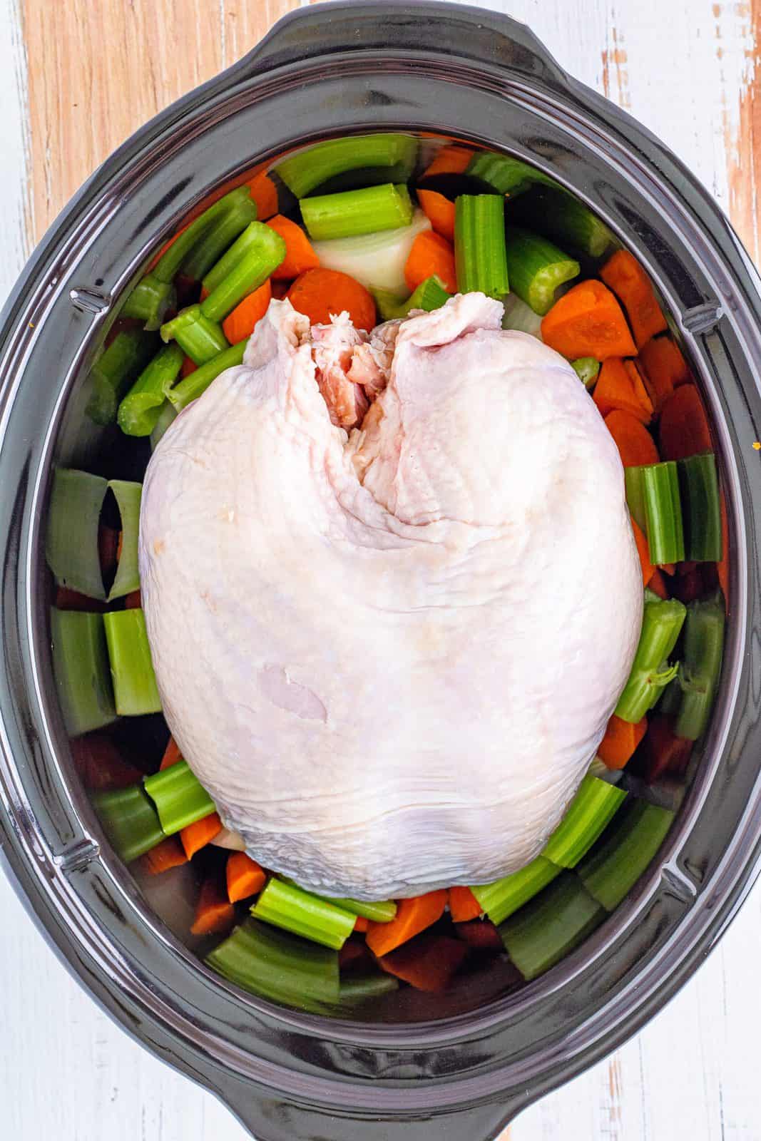 Turkey Breast added to crock pot over vegetables.
