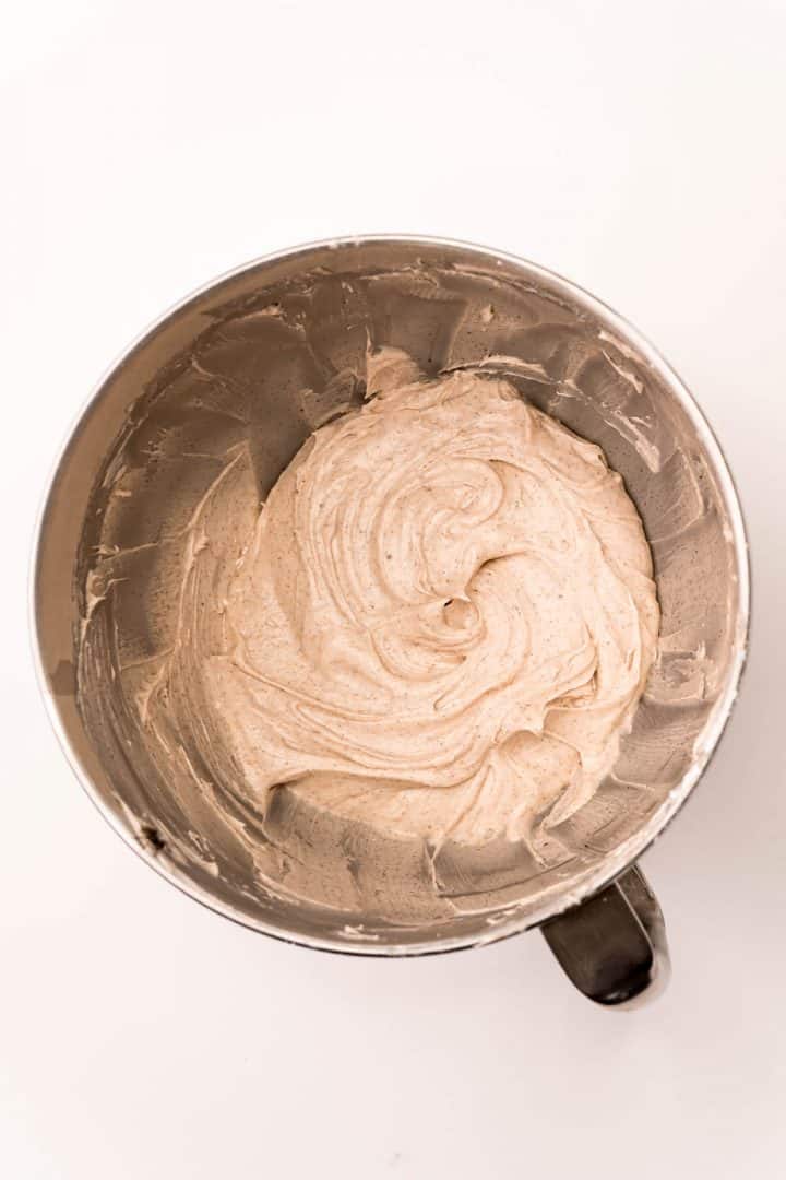 Frosting mixed together in bowl of stand mixer.