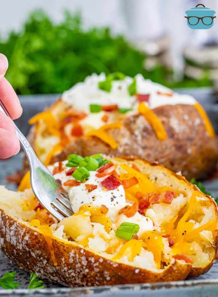 Fork going into one Outback Steakhouse Baked Potato.