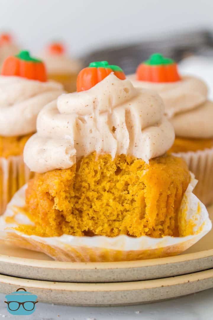 Liner pulled down from Homemade Pumpkin Cupcake with bite taken out.