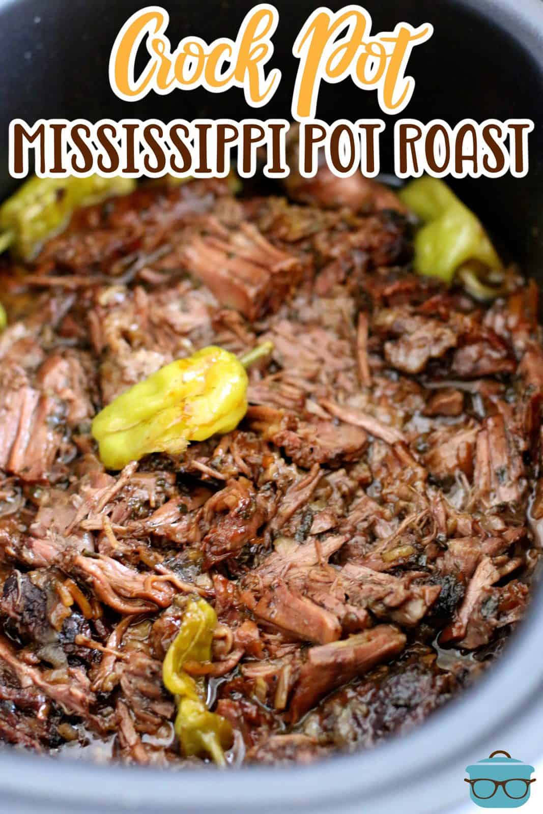shredded cooked  chuck roast with peperoncini peppers shown in an oval slow cooker.