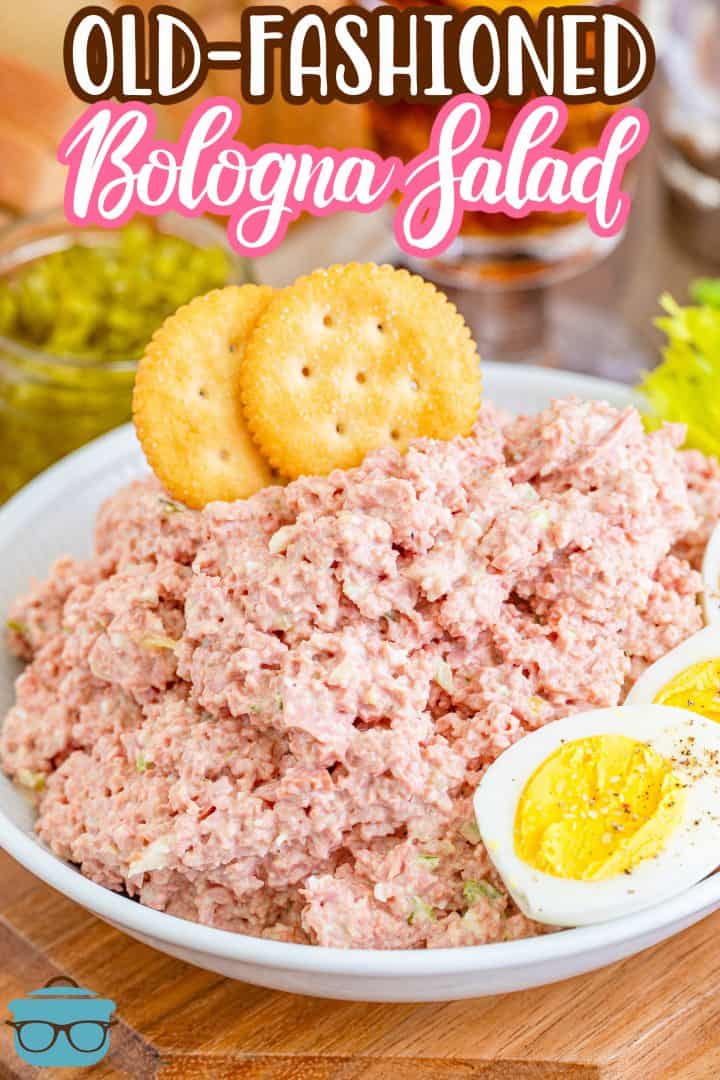Pinterest image of Old-Fashioned Bologna Salad in bowl with crackers and hard boiled eggs.