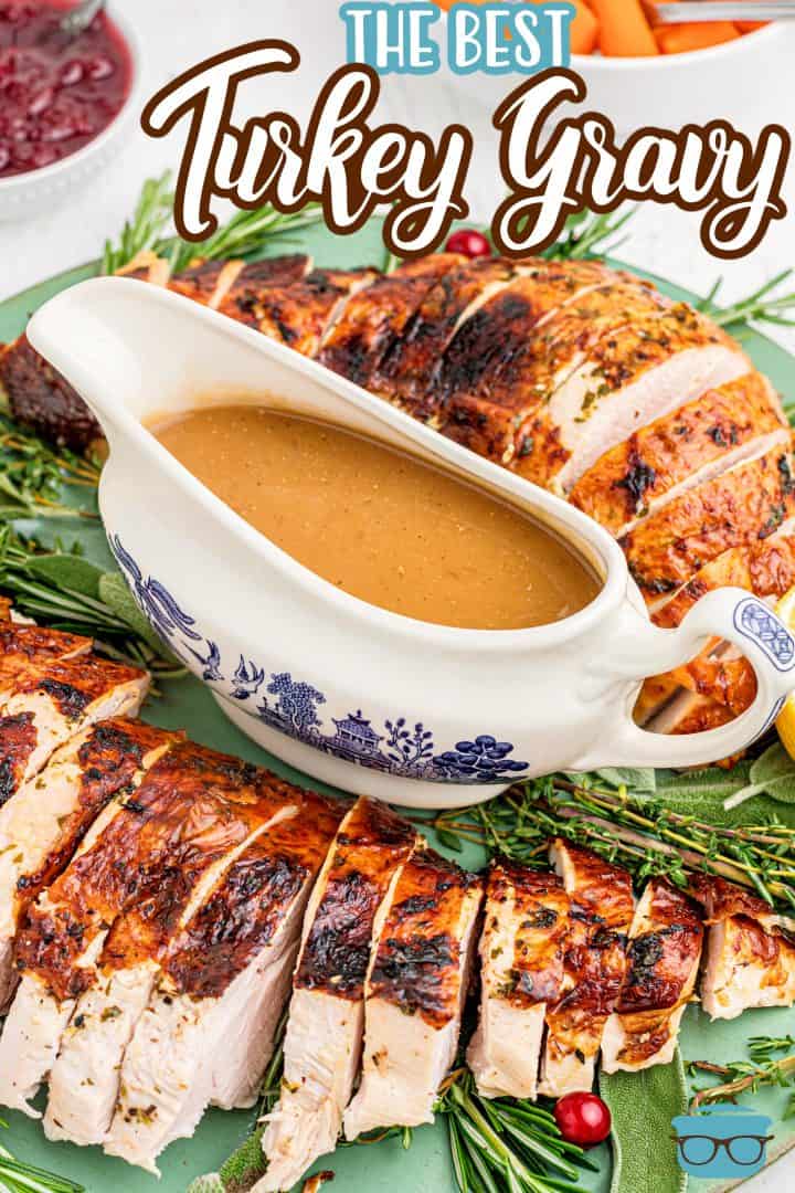 Pinterest image of The Best Turkey Gravy in gravy boat on platter with turkey and herbs.
