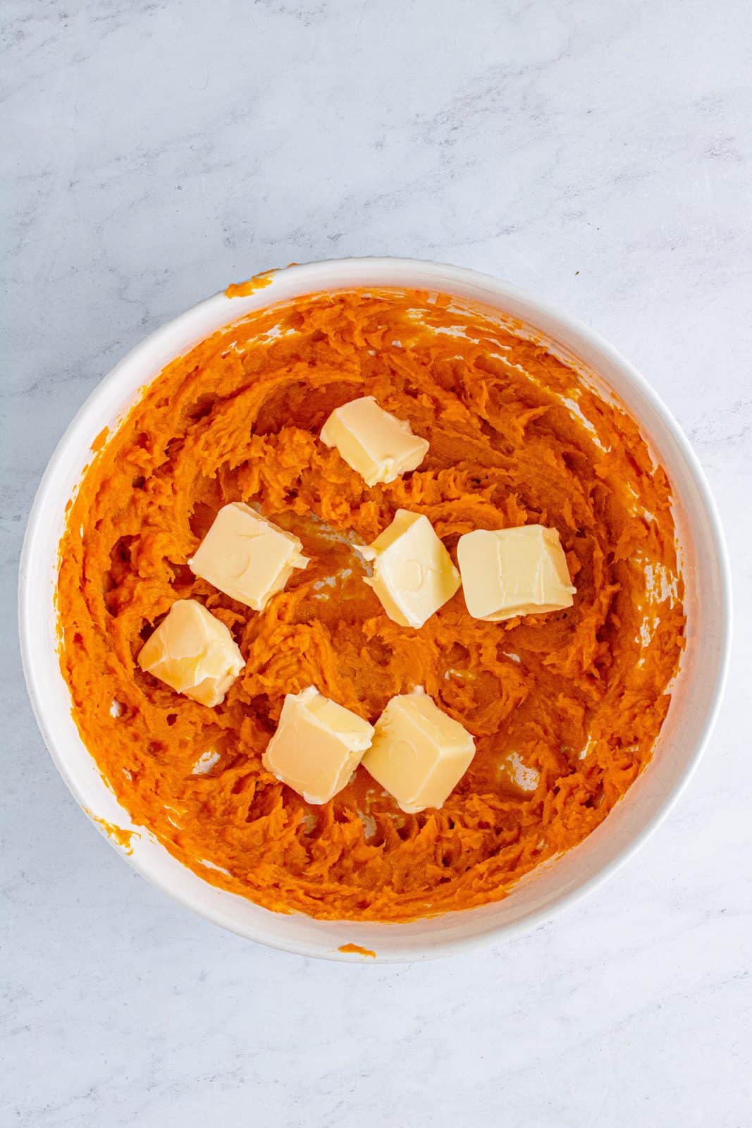 Butter added to blended sweet potatoes.