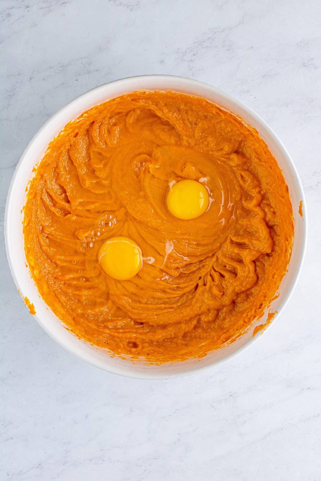 Eggs added to sweet potato mixture in bowl.