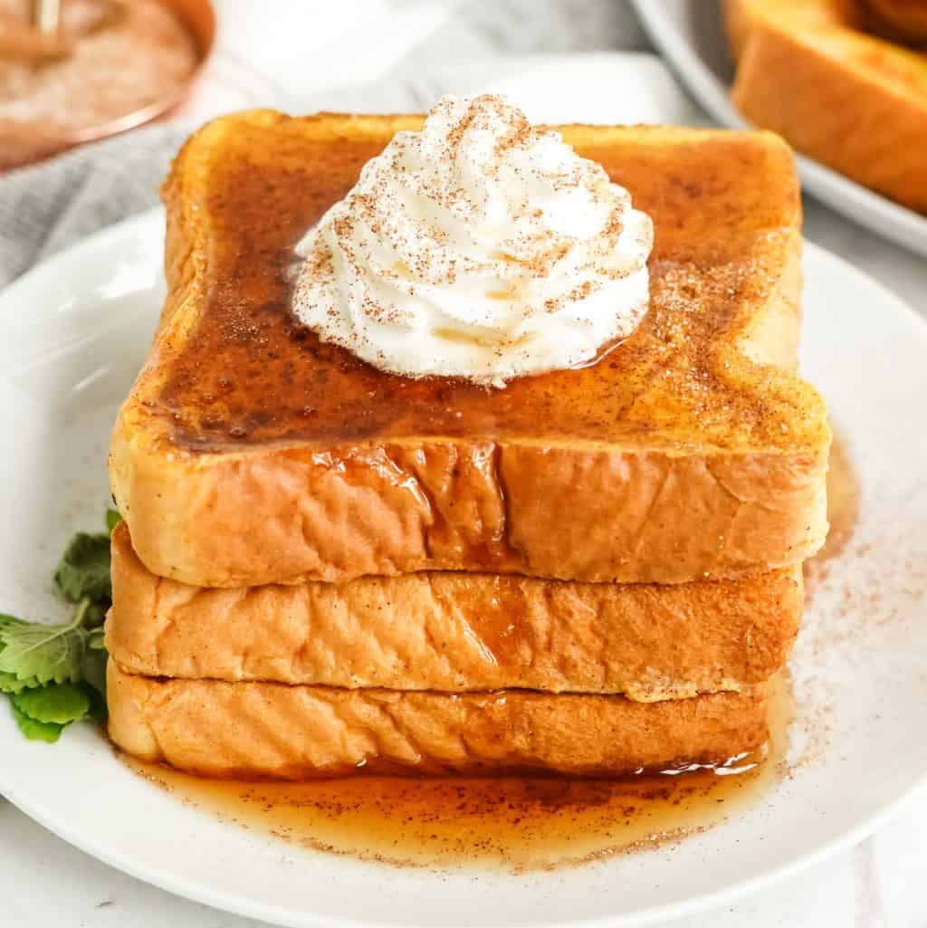 Square image of Pumpkin French Toast with syrup and whipped topping.