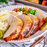 Square image of sliced and plated Crock Pot Mississippi Turkey Breast.